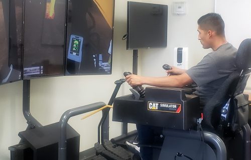 Using authentic Cat controls on the Cat Simulators Excavator system, a student, Jose Vergara, learns how to operate an excavator.