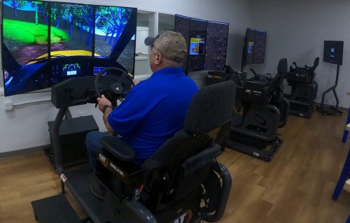 A TCAT Knoxville student practices operating skills he learned on the Cat Simulators Articulated Truck system.